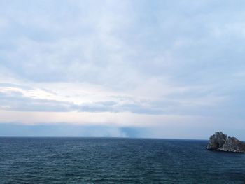 Scenic view of sea against cloudy sky
