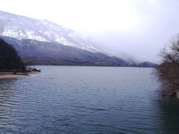 Scenic view of lake and mountains against sky