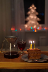 Close-up of illuminated candles on table