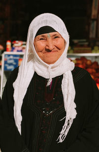 Portrait of smiling woman standing in snow