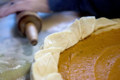 Cropped hand preparing food on table