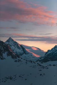 Scenic view of snowcapped mountains against sky during sunset