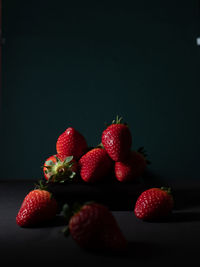 Close-up of strawberries on table against black background