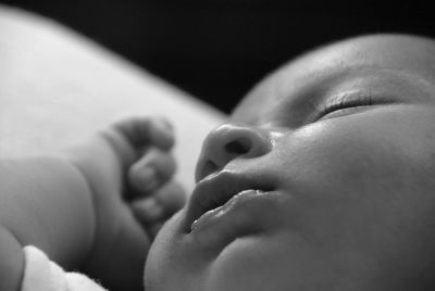 Close-up of baby girl sleeping at home