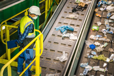 High angle view of man working in greenhouse