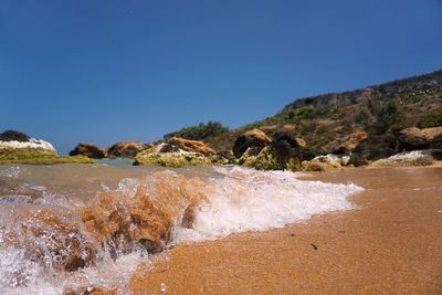 Scenic view of sea against clear blue sky