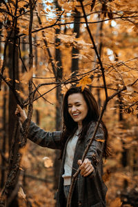 Autumn anxiety, mental health. happy brunette woman enjoy life in autumn forest