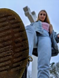 Portrait of woman standing by metal