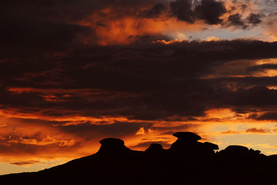 Silhouette of mountain against dramatic sky