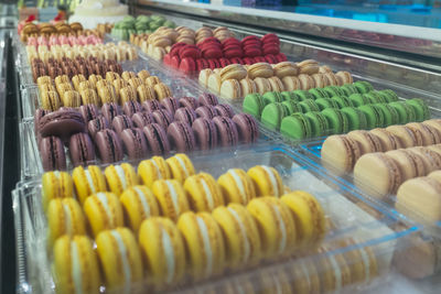 High angle view of colorful macaroons in container
