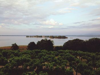 Scenic view of calm sea against cloudy sky