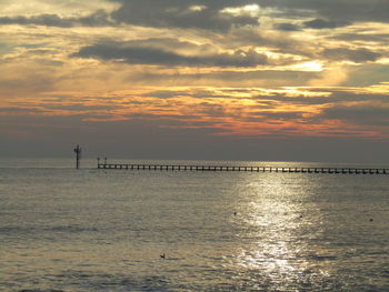 Scenic view of sea against orange sky