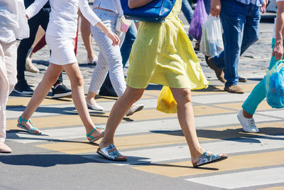 Low section of people walking on road