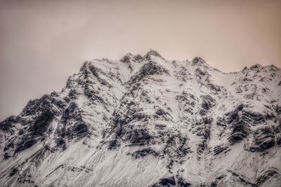 Scenic view of snowcapped mountains against clear sky