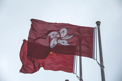 Low angle view of flag against clear sky