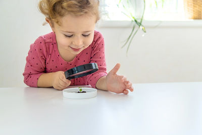 Boy playing with toy blocks on table