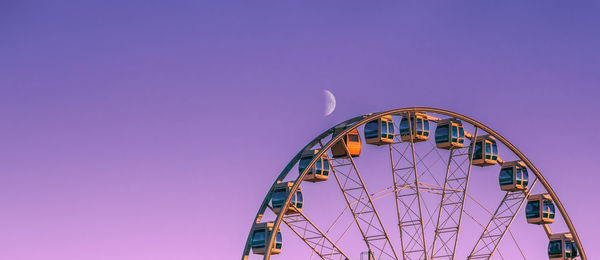 Low angle view of ferris wheel against sky