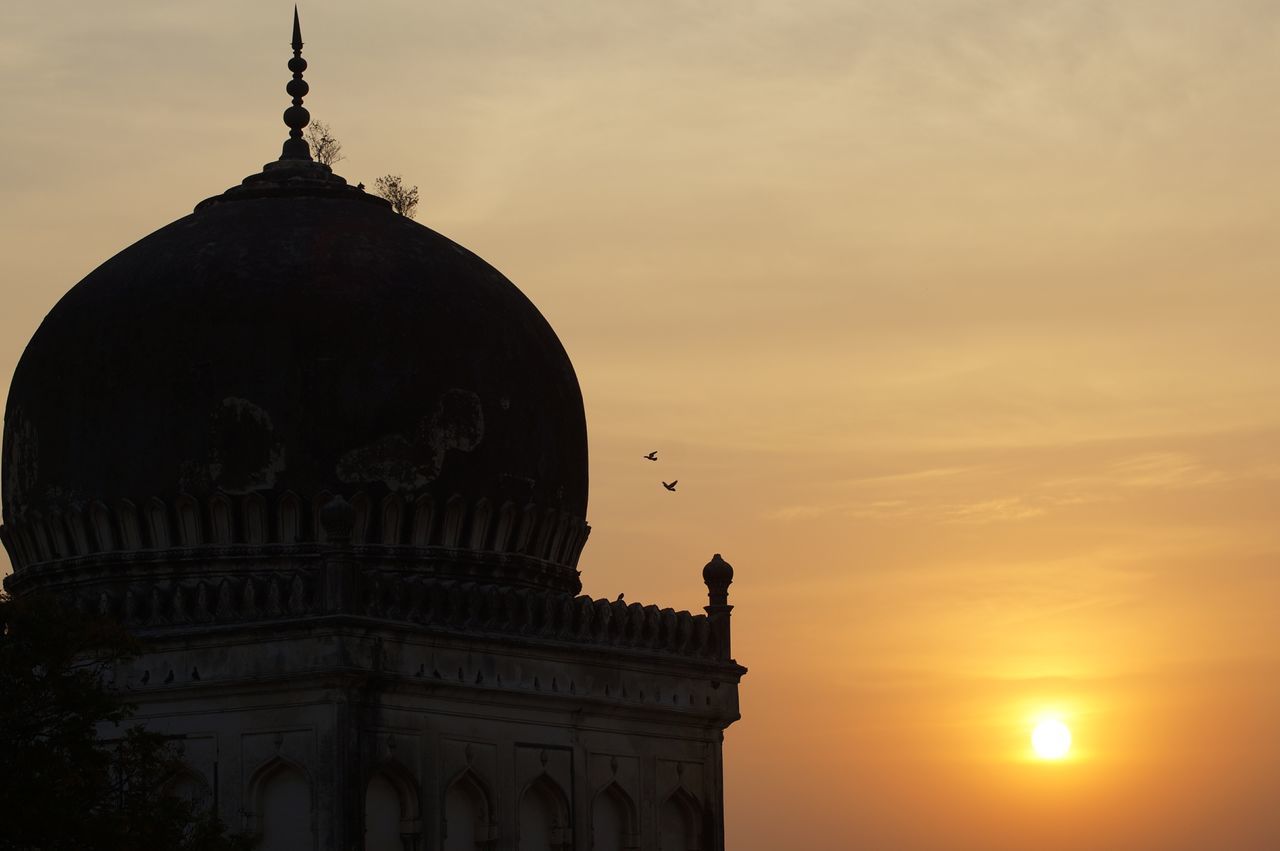 sunset, architecture, built structure, sky, building exterior, religion, place of worship, spirituality, statue, dome, sculpture, low angle view, orange color, art and craft, silhouette, famous place, art, travel destinations, cloud - sky