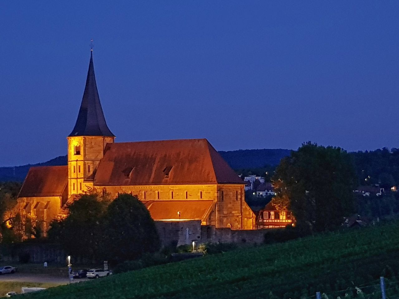 ILLUMINATED BUILDINGS AGAINST CLEAR SKY AT NIGHT