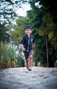 Portrait of boy running on plant