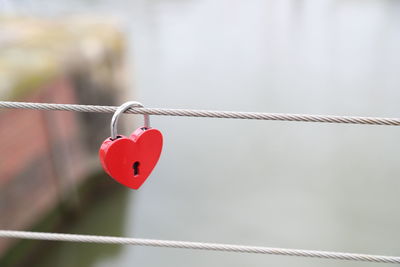 Close-up of heart shape padlock on rope