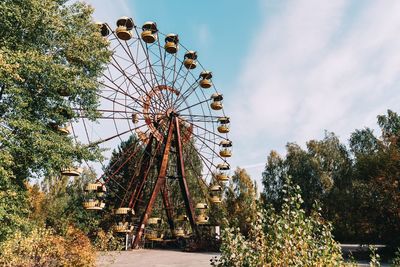 Low angle view of ferris wheel against sky