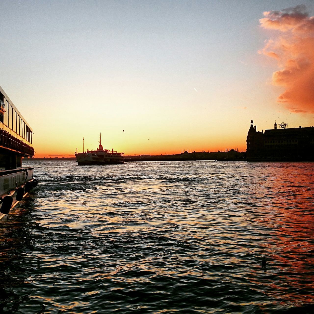 sunset, water, sea, waterfront, orange color, built structure, nautical vessel, copy space, building exterior, architecture, transportation, silhouette, scenics, beauty in nature, sky, rippled, boat, tranquil scene, nature, clear sky