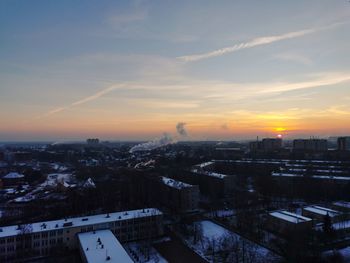 High angle view of buildings in city during sunset