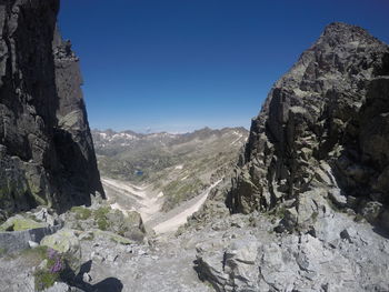 Scenic view of mountains against clear blue sky