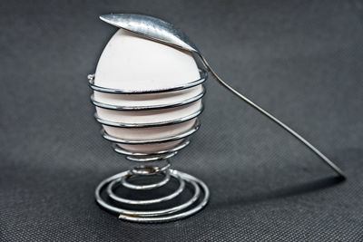 Close-up of egg and spoon on table