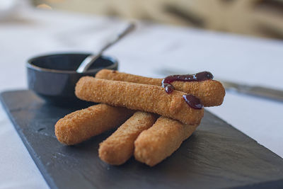 Fried mozzarella cheese fingers with blueberry sauce.