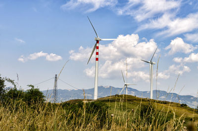 Windmill on field against sky