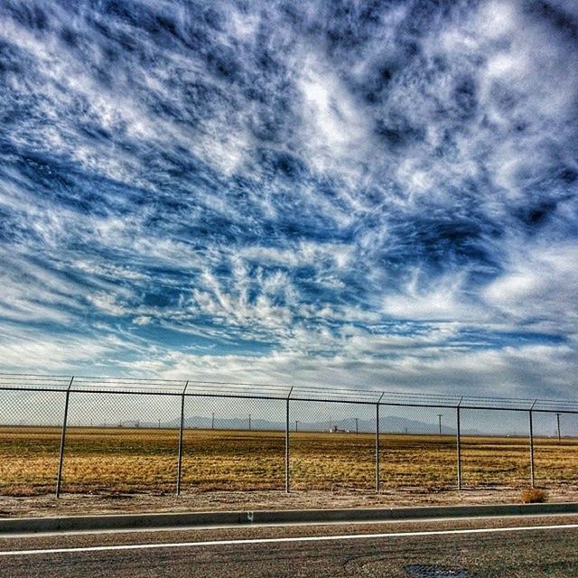 sky, cloud - sky, cloudy, transportation, road, cloud, landscape, field, the way forward, overcast, tranquil scene, tranquility, nature, scenics, cloudscape, dramatic sky, road marking, weather, diminishing perspective, beauty in nature