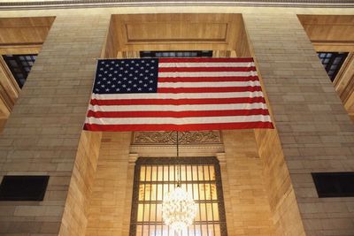 Low angle view of flag against building