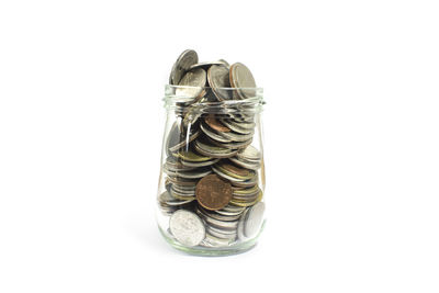 High angle view of coin in container against white background