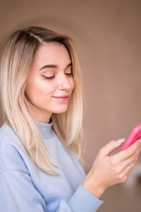 Beautiful young woman using smart phone