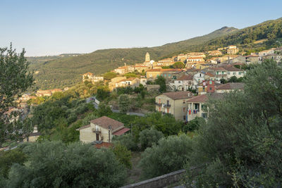 Buildings in town against clear sky