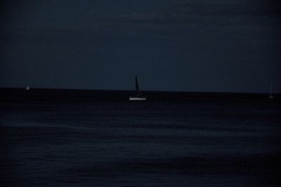 Sailboat sailing in sea against clear sky