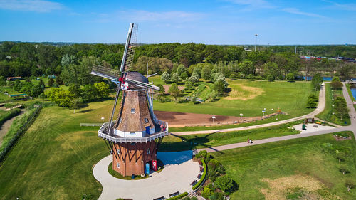 Traditional windmill on field against sky