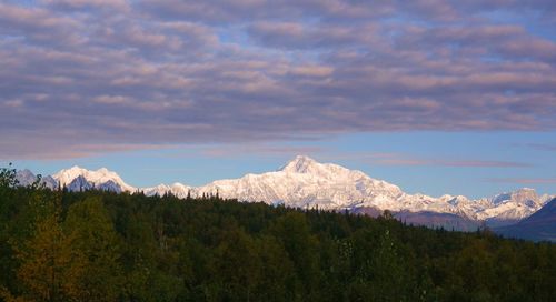 Scenic view of mountains against cloudy sky