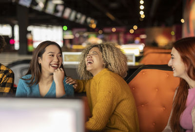 Woman with friends laughing at bowling alley