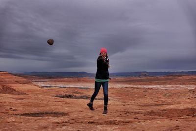 View of woman throwing a rock