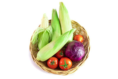 High angle view of fruits in basket on white background