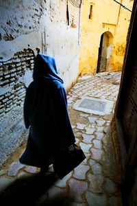 Rear view of a woman sitting outdoors