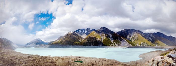 Panoramic view of sea and mountains against sky