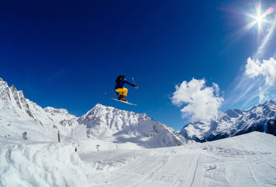 Low angle view of person jumping on ski slope