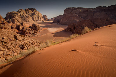 Sand dunes in desert against sky