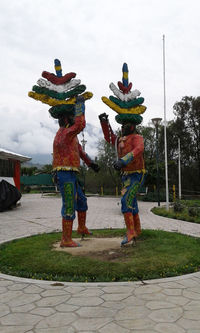 People standing on column against sky