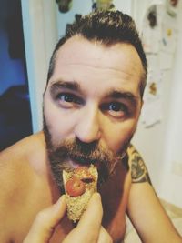 Portrait of young man eating food