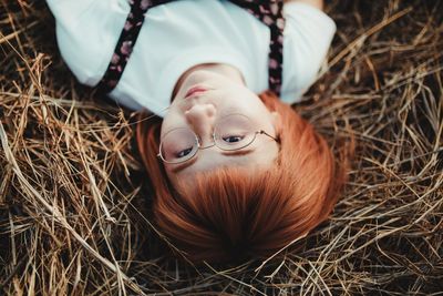 High angle view of woman lying on field